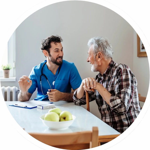 An advocate talking through a care plan with an older client at a kitchen table